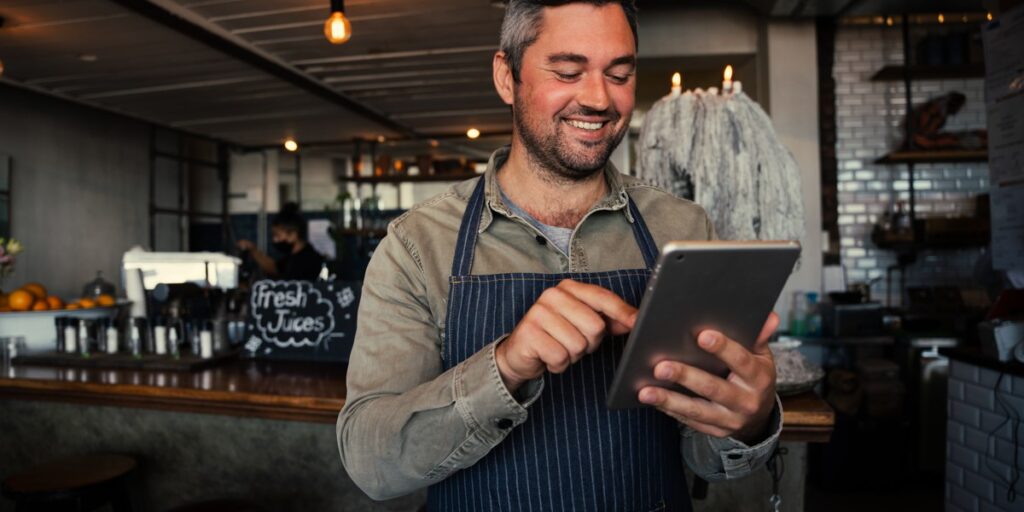 a restaurant worker placing an order on a tablet