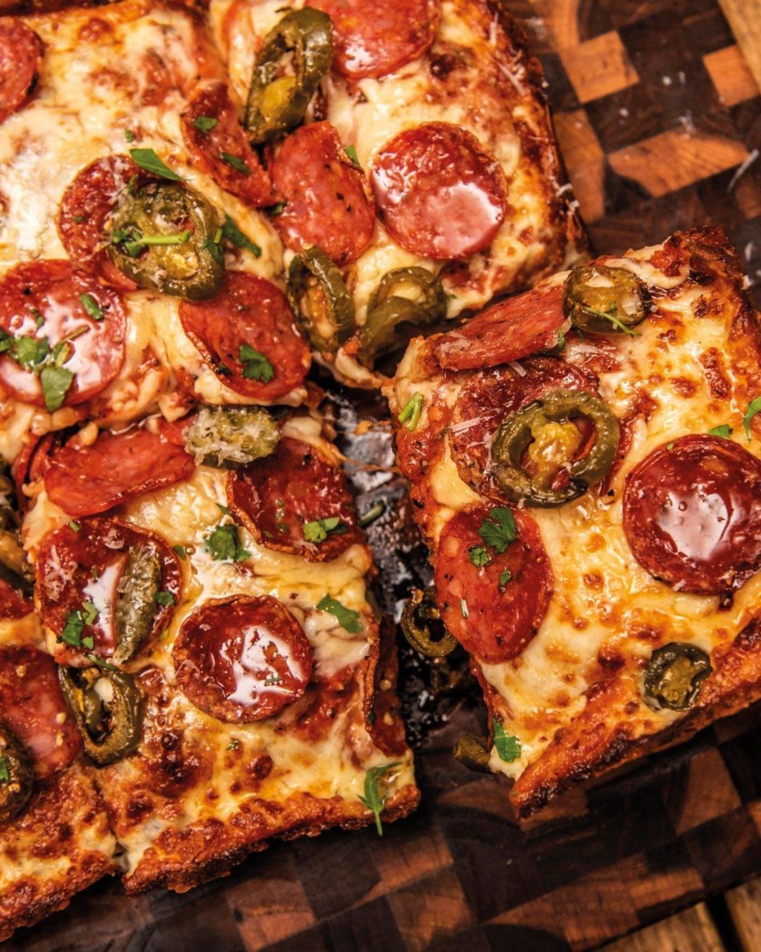 A Detroit-style pepperoni and jalapeño pizza, cut into squares